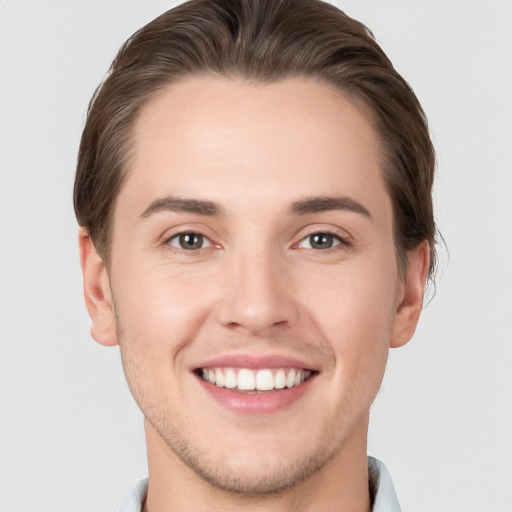 Joyful white young-adult male with short  brown hair and brown eyes