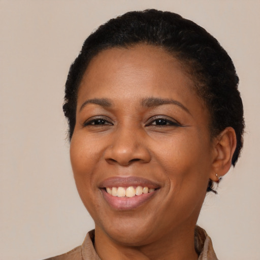 Joyful latino adult female with short  black hair and brown eyes
