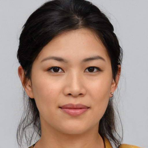 Joyful asian young-adult female with medium  brown hair and brown eyes