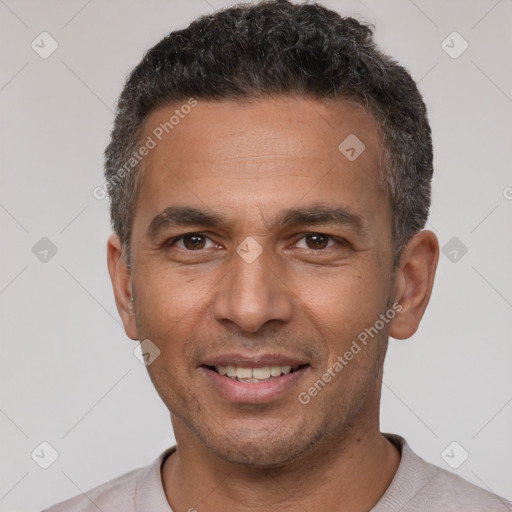 Joyful latino adult male with short  black hair and brown eyes