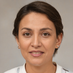 Joyful white adult female with medium  brown hair and brown eyes