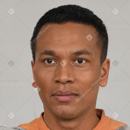 Neutral latino young-adult male with short  black hair and brown eyes
