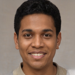 Joyful latino young-adult male with short  black hair and brown eyes