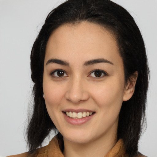 Joyful latino young-adult female with medium  brown hair and brown eyes