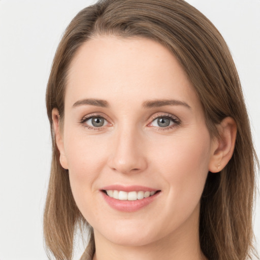 Joyful white young-adult female with long  brown hair and grey eyes