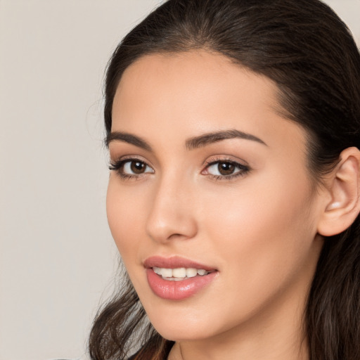 Joyful white young-adult female with long  brown hair and brown eyes