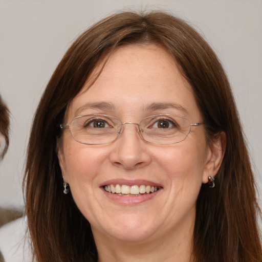 Joyful white adult female with long  brown hair and brown eyes