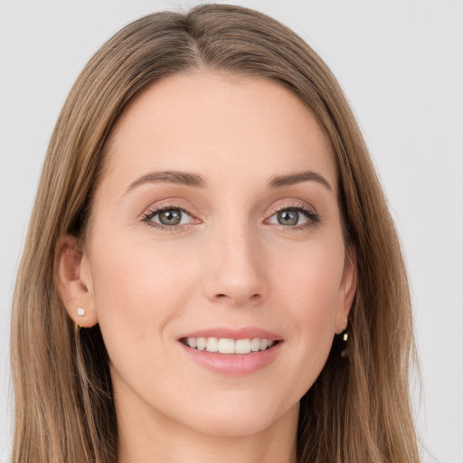 Joyful white young-adult female with long  brown hair and grey eyes