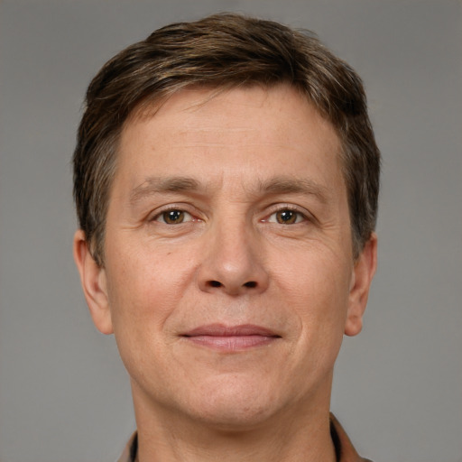 Joyful white adult male with short  brown hair and grey eyes