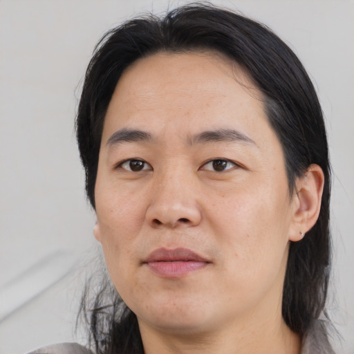 Joyful asian adult male with medium  black hair and brown eyes