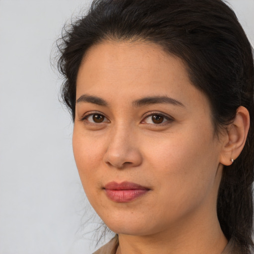 Joyful latino young-adult female with medium  brown hair and brown eyes