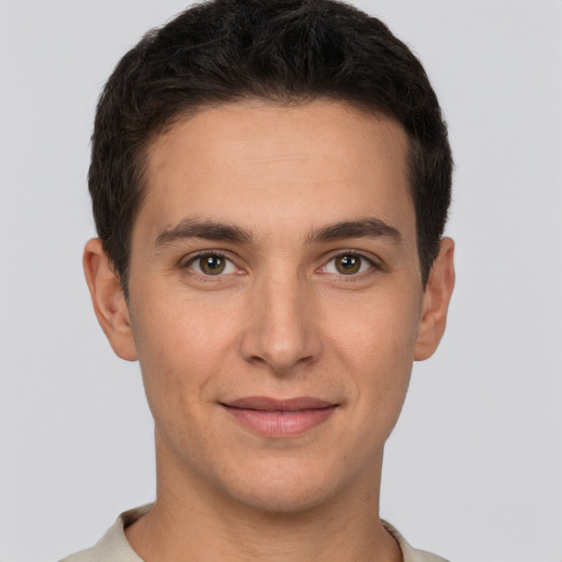 Joyful white young-adult male with short  brown hair and brown eyes