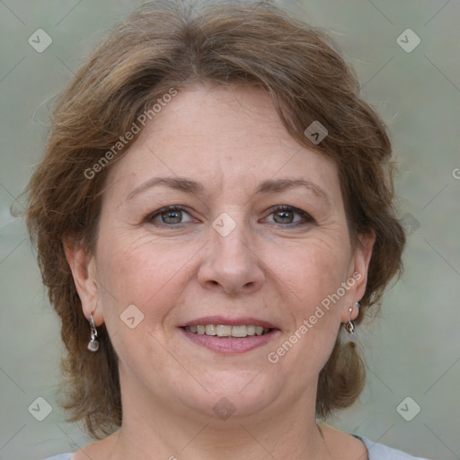 Joyful white adult female with medium  brown hair and grey eyes