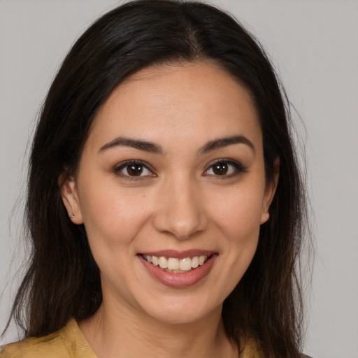 Joyful white young-adult female with long  brown hair and brown eyes