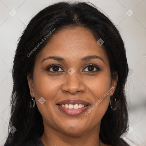 Joyful black young-adult female with long  brown hair and brown eyes