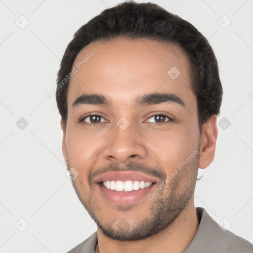 Joyful white young-adult male with short  black hair and brown eyes