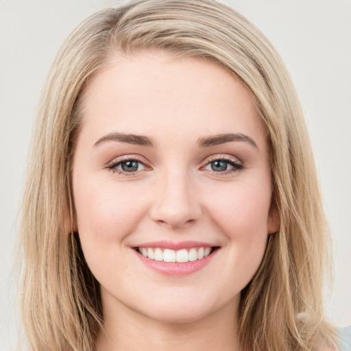 Joyful white young-adult female with long  brown hair and blue eyes