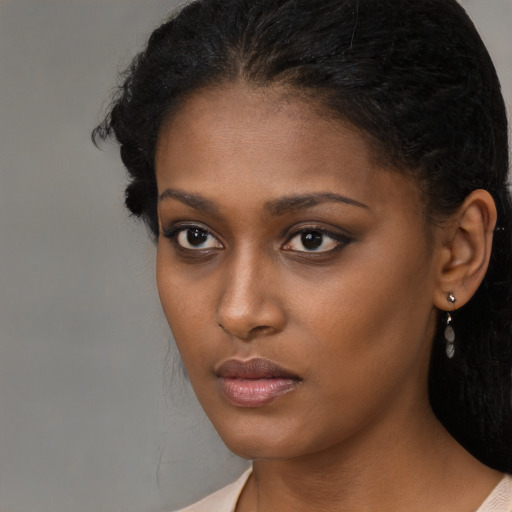 Neutral black young-adult female with long  brown hair and brown eyes