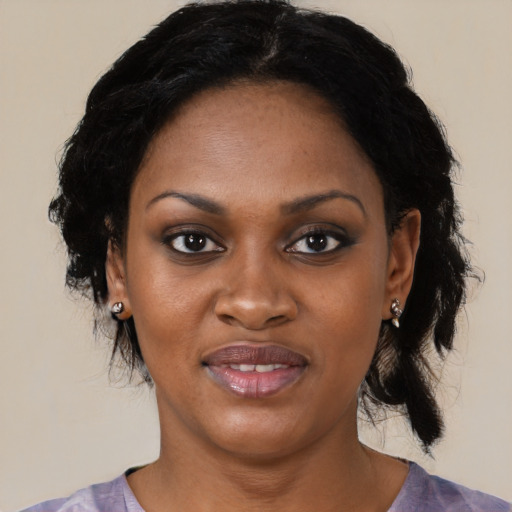 Joyful black young-adult female with medium  black hair and brown eyes