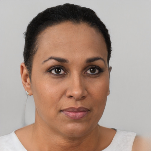 Joyful black adult female with short  brown hair and brown eyes