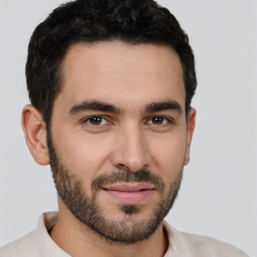 Joyful white young-adult male with short  black hair and brown eyes