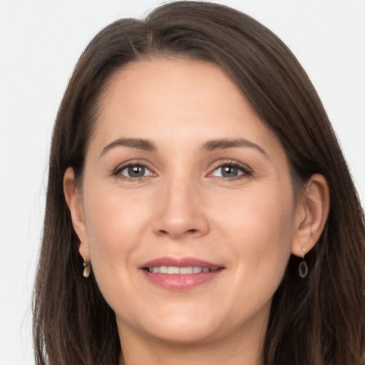 Joyful white adult female with long  brown hair and brown eyes