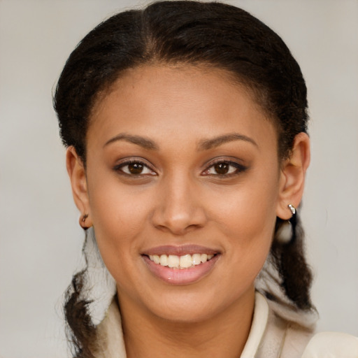 Joyful latino young-adult female with short  brown hair and brown eyes