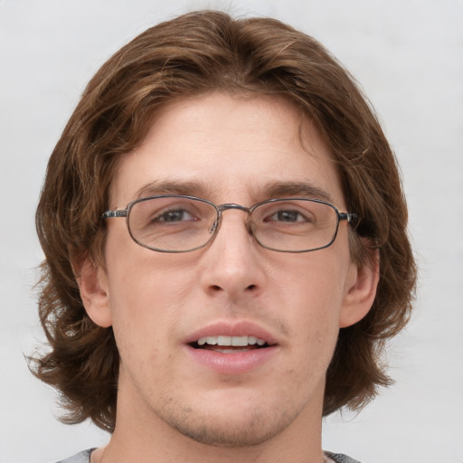 Joyful white adult male with medium  brown hair and grey eyes