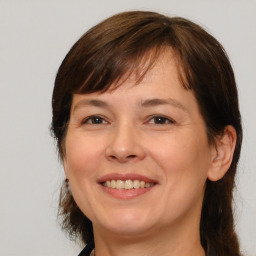 Joyful white adult female with medium  brown hair and brown eyes