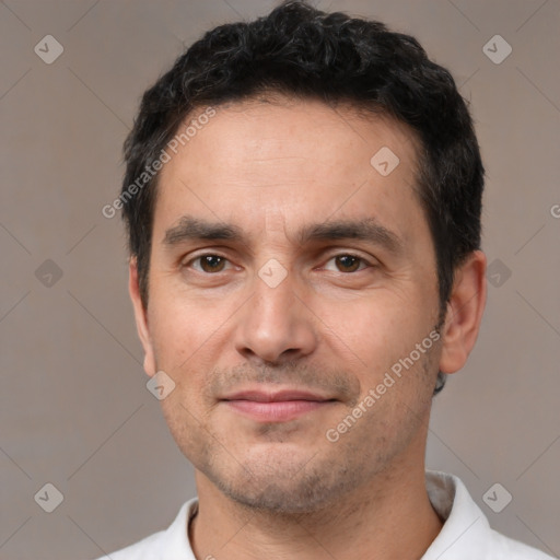 Joyful white young-adult male with short  black hair and brown eyes