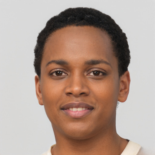Joyful black young-adult female with short  black hair and brown eyes