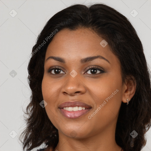 Joyful black young-adult female with long  brown hair and brown eyes