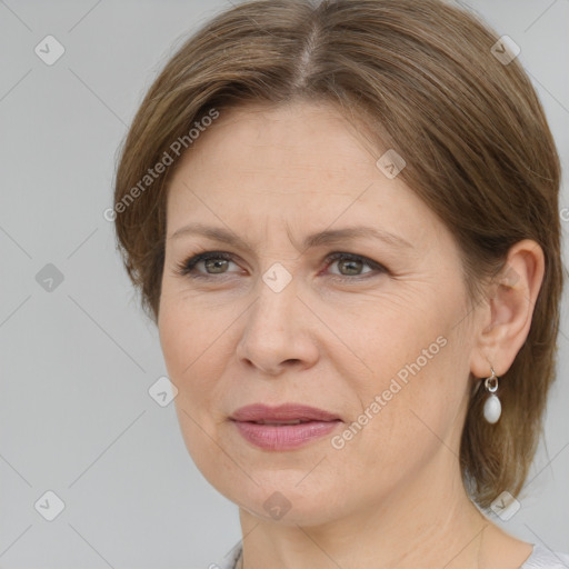 Joyful white adult female with medium  brown hair and grey eyes