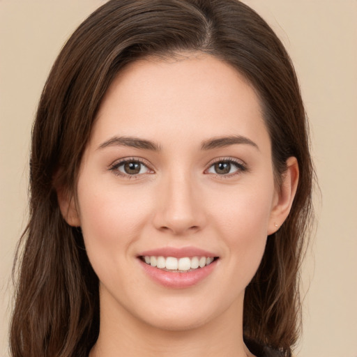 Joyful white young-adult female with long  brown hair and brown eyes