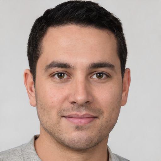 Joyful white young-adult male with short  brown hair and brown eyes