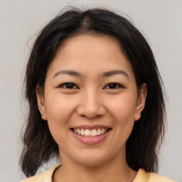 Joyful asian young-adult female with medium  brown hair and brown eyes