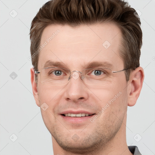 Joyful white adult male with short  brown hair and grey eyes