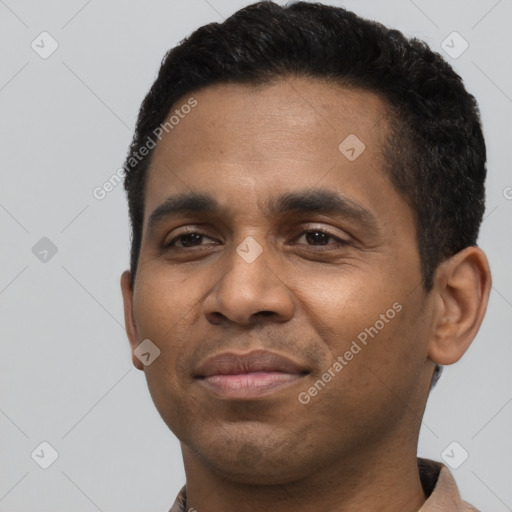 Joyful latino young-adult male with short  black hair and brown eyes