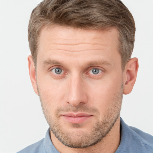 Joyful white adult male with short  brown hair and grey eyes