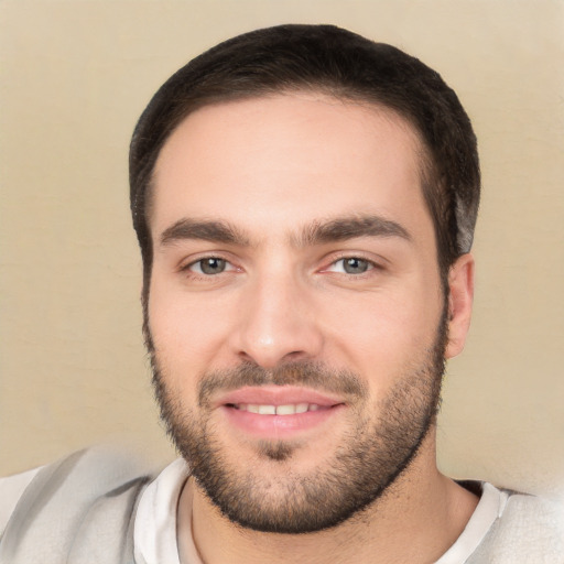 Joyful white young-adult male with short  black hair and brown eyes