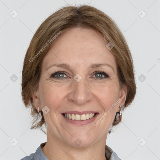 Joyful white adult female with medium  brown hair and grey eyes