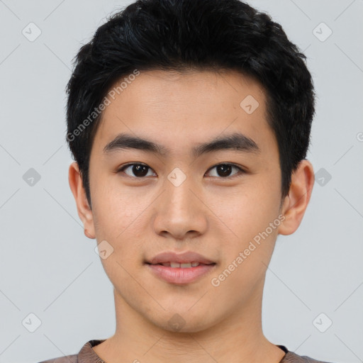 Joyful asian young-adult male with short  black hair and brown eyes