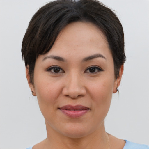 Joyful asian young-adult female with short  brown hair and brown eyes