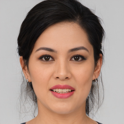 Joyful asian young-adult female with medium  black hair and brown eyes