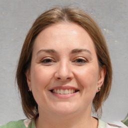 Joyful white young-adult female with medium  brown hair and blue eyes