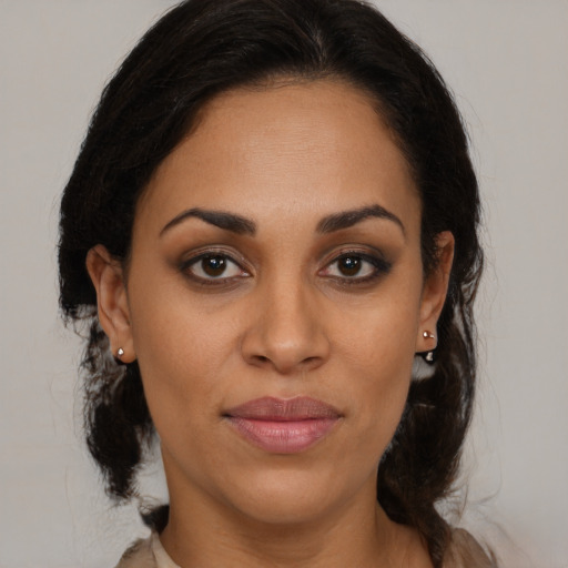 Joyful latino young-adult female with medium  brown hair and brown eyes
