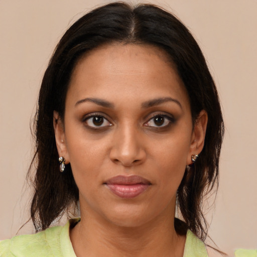 Joyful black young-adult female with medium  brown hair and brown eyes