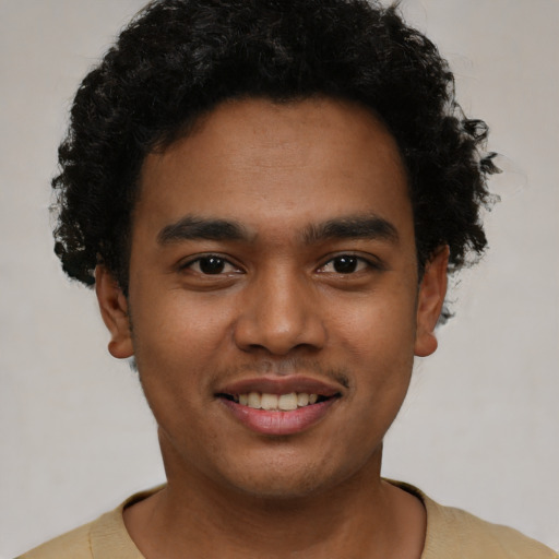 Joyful black young-adult male with short  black hair and brown eyes