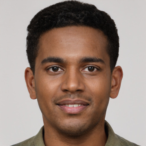 Joyful black young-adult male with short  brown hair and brown eyes