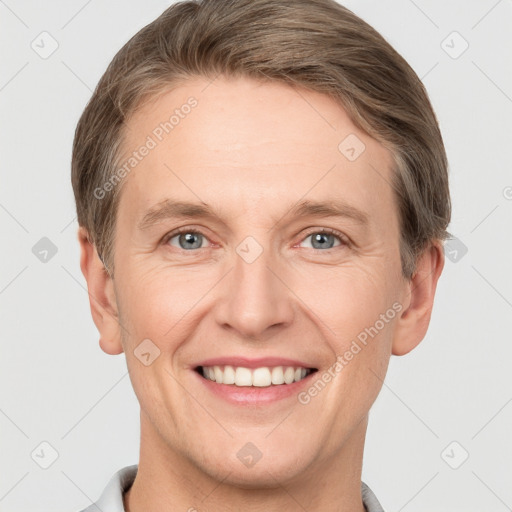 Joyful white adult male with short  brown hair and grey eyes